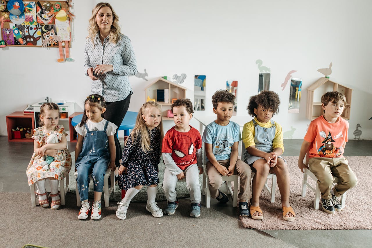 Children and teacher in a bright, diverse kindergarten classroom, enjoying games and learning.